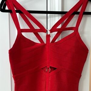 Red Body Con Bebe Dress with cutouts.